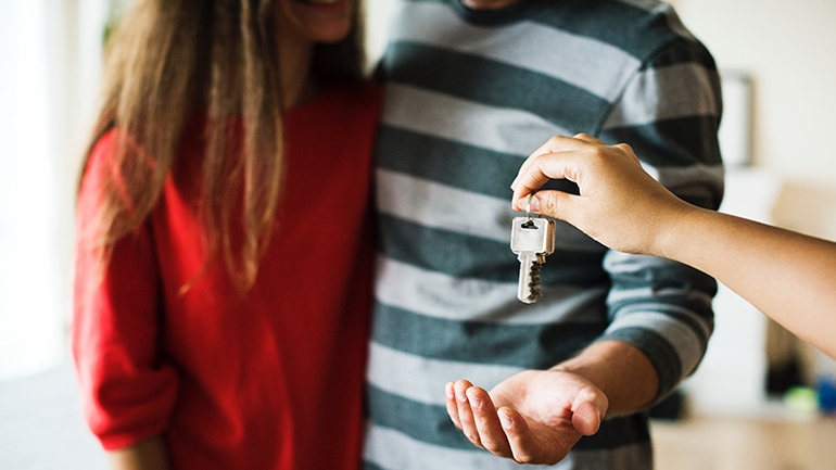 couple holding keys for new home