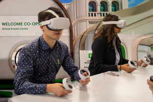 Intern using VR headset to interacted with colleagues in the TD metaverse.