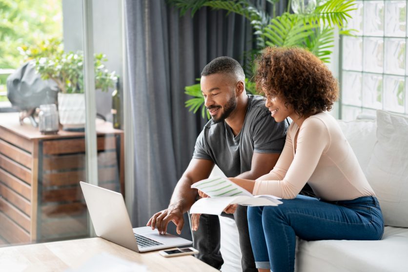 couple looking at finances on laptop